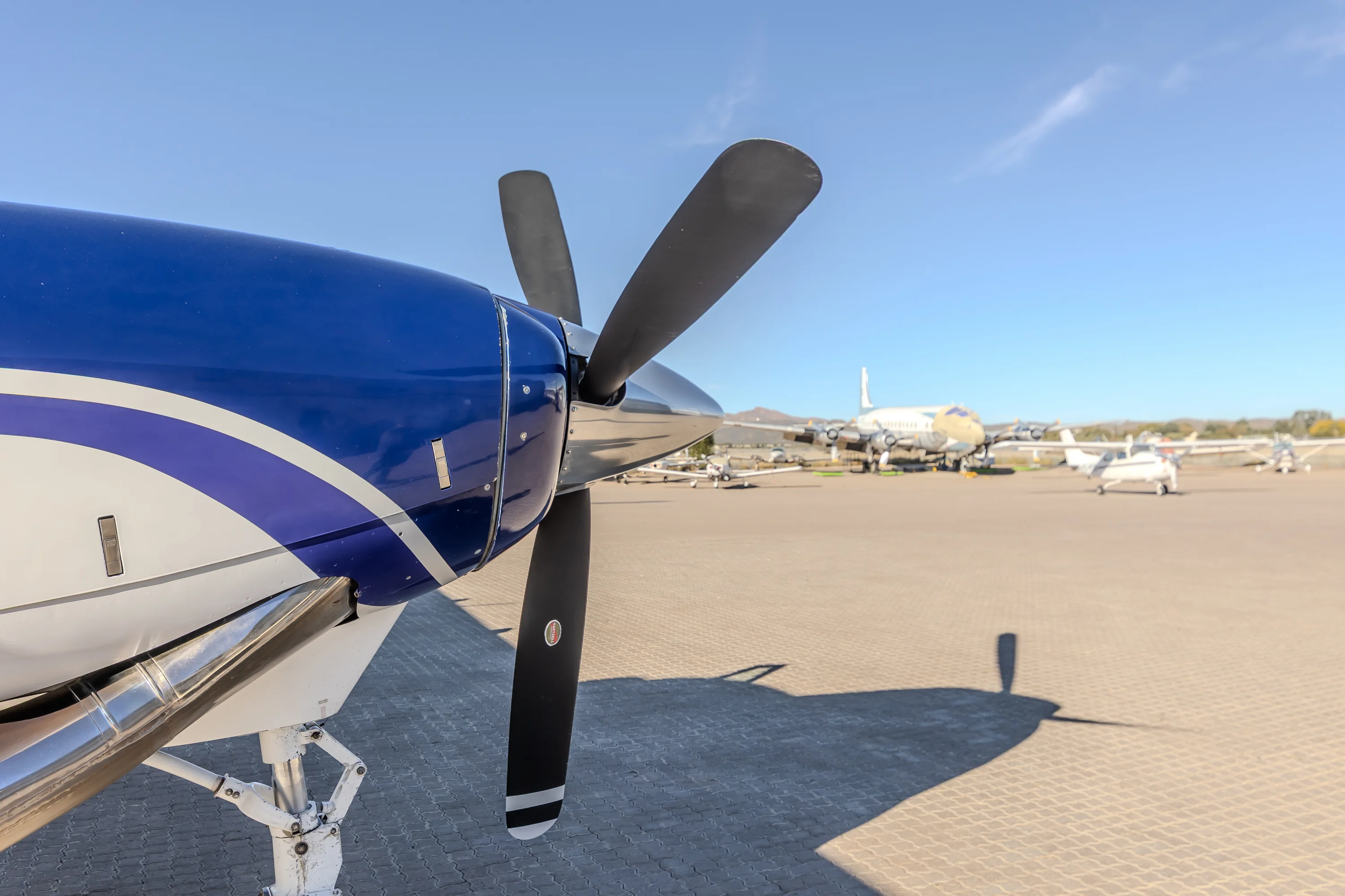 Blue aircraft and propeller on the airport apron