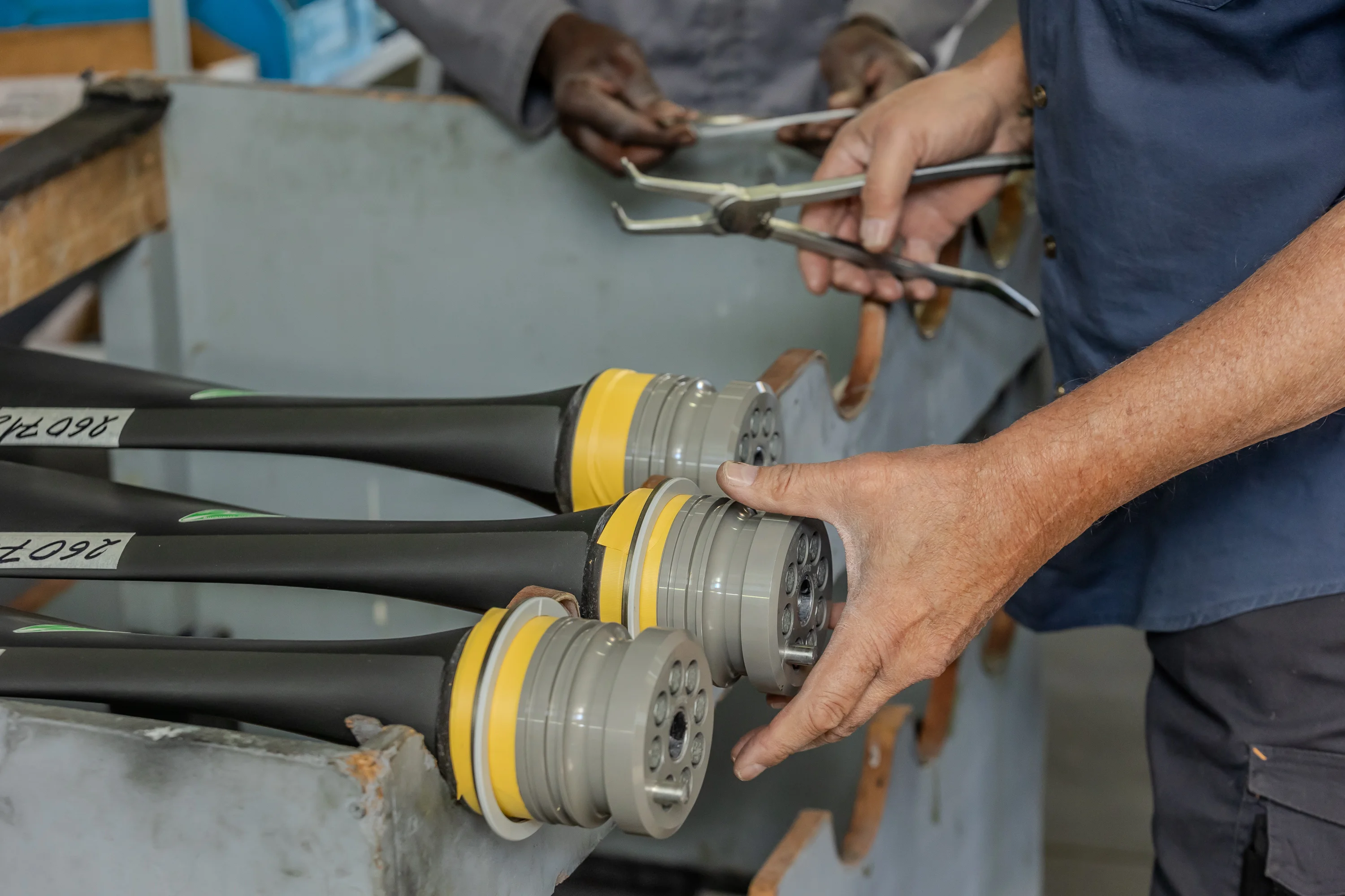 Technicians working together on propeller components